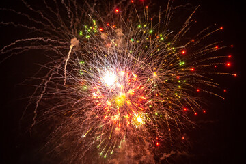 Holiday fireworks explode in the night sky. 4th of July celebration. Selective focus. 
