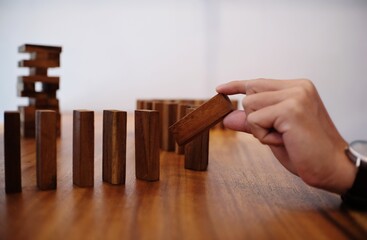 Planning risk and strategy in businessman gambling placing wooden block.Business concept for growth...