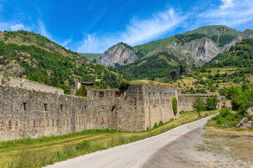 Fototapeta na wymiar Narrow road and old military fort in the mountains in Vinadio, Italy.