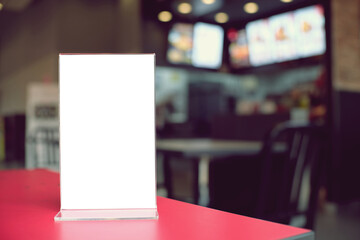 Mock up Menu frame standing on wood table in Bar restaurant cafe. space for text