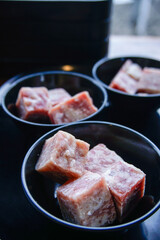 Cubes of raw beef meat in bowl