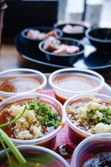 The sauce is placed in a plastic cup.