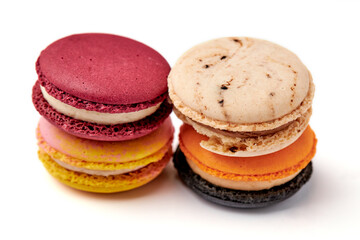 4 colorful macarons (pink, red, orange and cream-brown) isolated on white background.