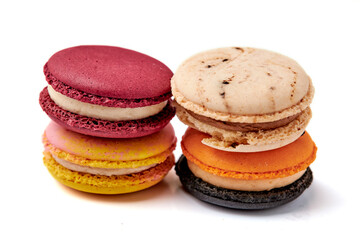 4 colorful macarons (pink, red, orange and cream-brown) isolated on white background.