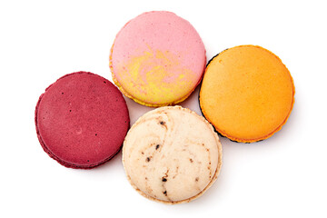 Top view of 4 colorful macarons (pink, red, orange and cream-brown) isolated on white background.