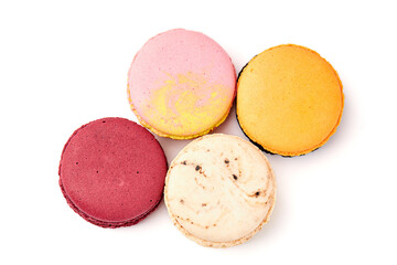 Top view of 4 colorful macarons (pink, red, orange and cream-brown) isolated on white background.