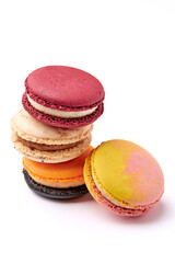 Stacking of 3 colorful macarons (red, orange and cream-brown) and pink isolated on white background.