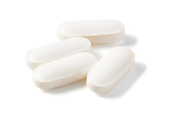 Top view of Many long-shaped white pills isolated on a white background.