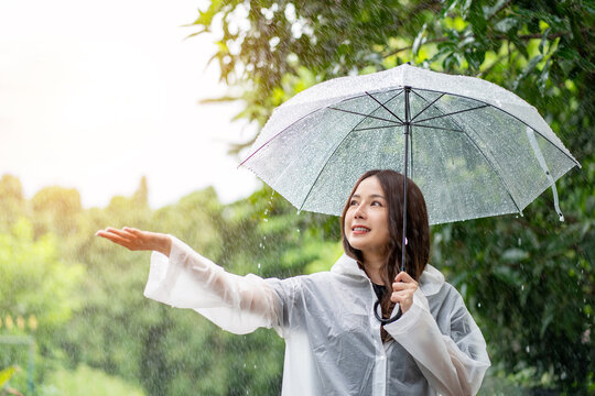 Woman holding an umbrella while it rains