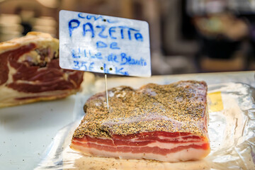 Panzetta Corsican dry cured seasoned and smoked pork belly at a provencal farmers market in old...