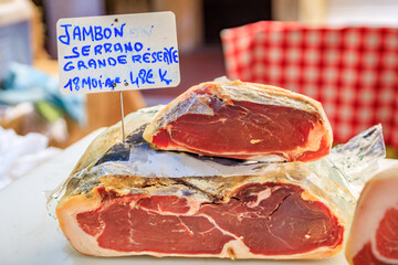 Antibes, France - May 24, 2023: Italian serrano ham, dry cured pork cold cut for sale at a local...