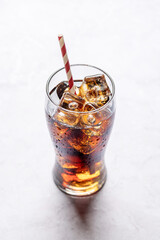 Refreshing glass of cola with ice