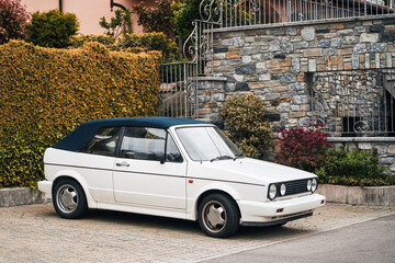 Retro cabriolet. Convertible vehicle. White 80s European compact convertible hatchback car. - obrazy, fototapety, plakaty