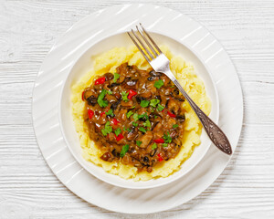 potato mash topped with mushroom gravy in bowl