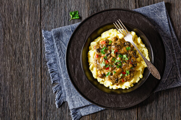 potato mash topped with mushroom gravy in bowl