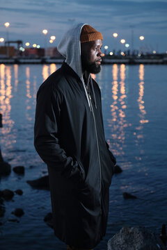 Solitude: African American Man Standing Alone near a Canal at Night
