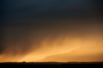 Dark sky with sunset over mountains
