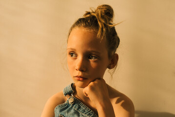 portrait of a young girl with dungarees & freckles