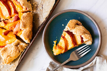 A teal plate with a slice of freshly baked nectarine galette