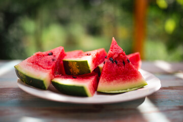 Slices of watermelon on a garden table.