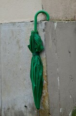 Green umbrella on the corner of a house