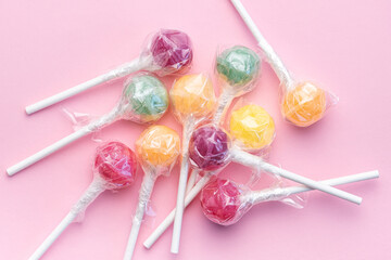 Sweet lollipops on pink background