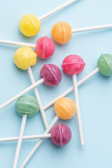 Sweet lollipops and candies on blue background