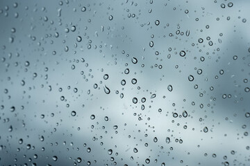 raindrops drops on car glass sky background