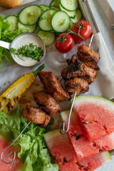 Grilled pork shish kebab on skewers with vegetables