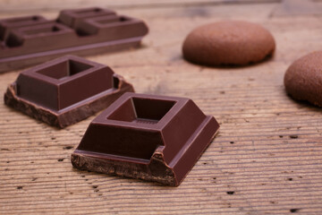 dark chocolate squares on rustic wooden table