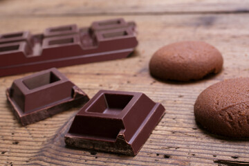 dark chocolate squares on rustic wooden table