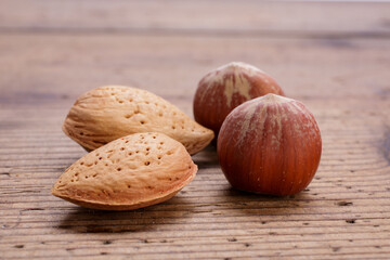hazelnuts and almonds in shell on wooden rustic table