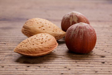 hazelnuts and almonds in shell on wooden rustic table