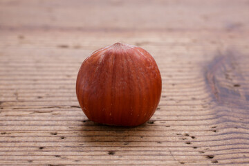 hazelnut with shell on rustic wooden table