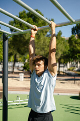 Strong young sportsman doing calisthenics