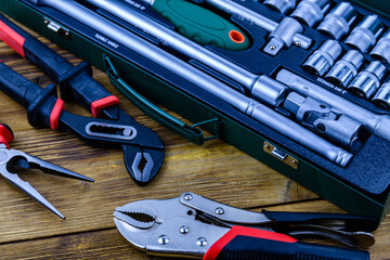 Socket set with socket wrench, adjustable water pump pliers, needle nose pliers and locking pliers. Toolkit for the car maintenance