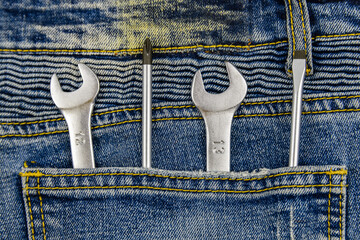 Spanners and screwdrivers in rear pocket of the jeans. Top view