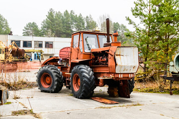 Fototapeta na wymiar Abandoned soviet tractor at the Chernobyl exclusion zone, Ukraine