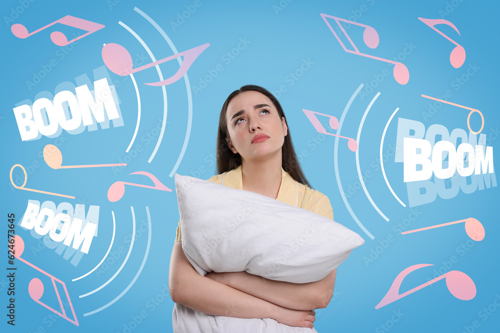 Canvas Prints Insomnia. Exhausted woman with pillow can`t falling asleep because of noise on light blue background. Different music notes and words Boom around her