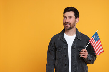 4th of July - Independence Day of USA. Happy man with American flag on yellow background, space for...