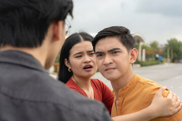 A young asian lady tries to restrain her hotheaded boyfriend from hitting an old ex-partner or a...