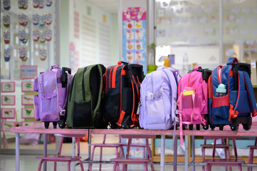 A school bags on the kindergarten school desk in the classroom education and concept of colorful school bags in school