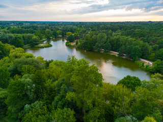 Lake and a park path surrounded with trees in Poland seen from above