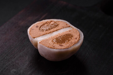 Delicious sweet mochi dessert with toppings on a dark concrete background