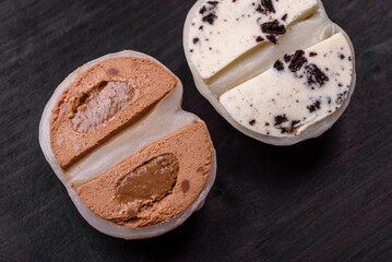 Delicious sweet mochi dessert with toppings on a dark concrete background