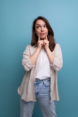 pretty young brunette female adult in casual shirt on studio background