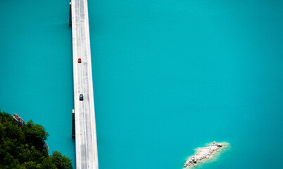 Scenic bridge over canyon lake Piva in Montenegro from above with beautiful color os water. Aerial drone view on nature in national park