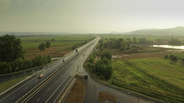 4K aerial video from above with A1 highway road between Sebes and Deva. Drone video with the roads of Romania. Aerial view during sunset after a summer storm.