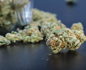 marijuana or weed flowers on black background