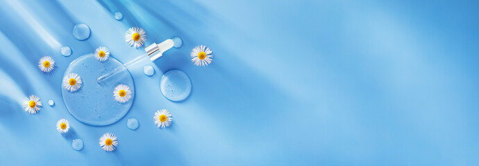 serum dropper on a blue background with chamomile flowers transparent gel